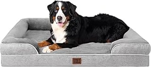 A large dog is laying on a dog bed.