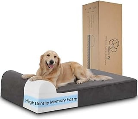 A dog is laying on a dog bed.