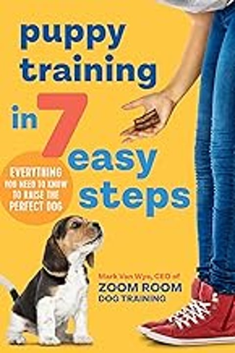 A woman holding a dog in her hand and a book titled Puppy Training in 7 Easy Steps.