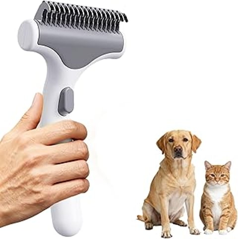 A person holding a brush for dogs and cats.